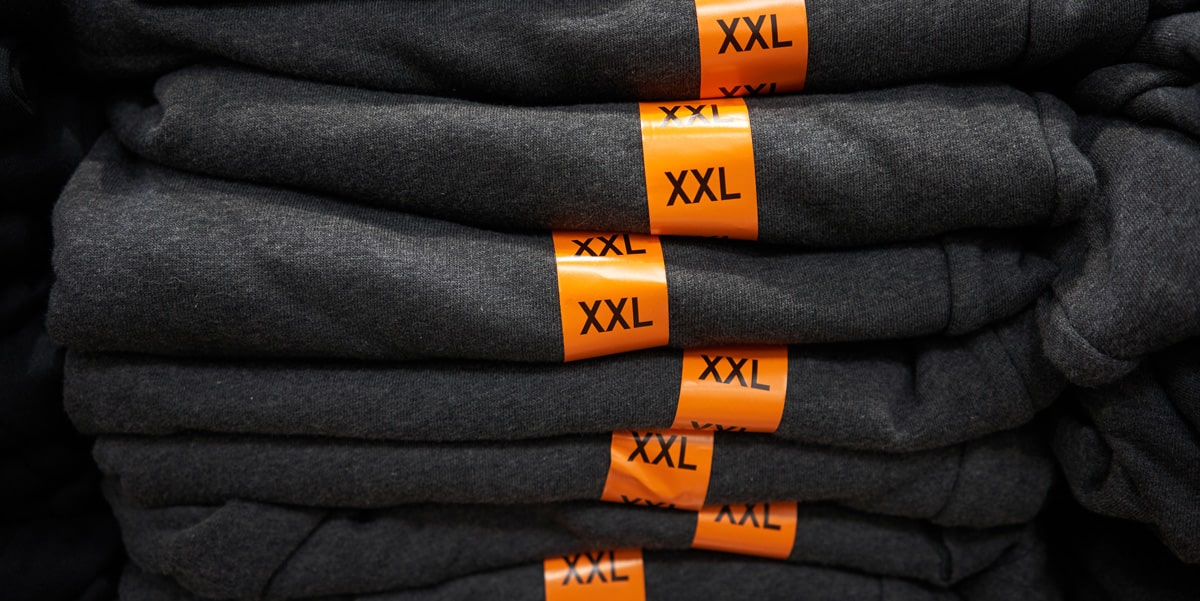 Orange size labels on grey apparel