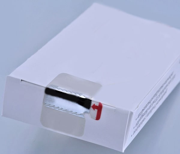 Small white box with white metal and white label on the tab